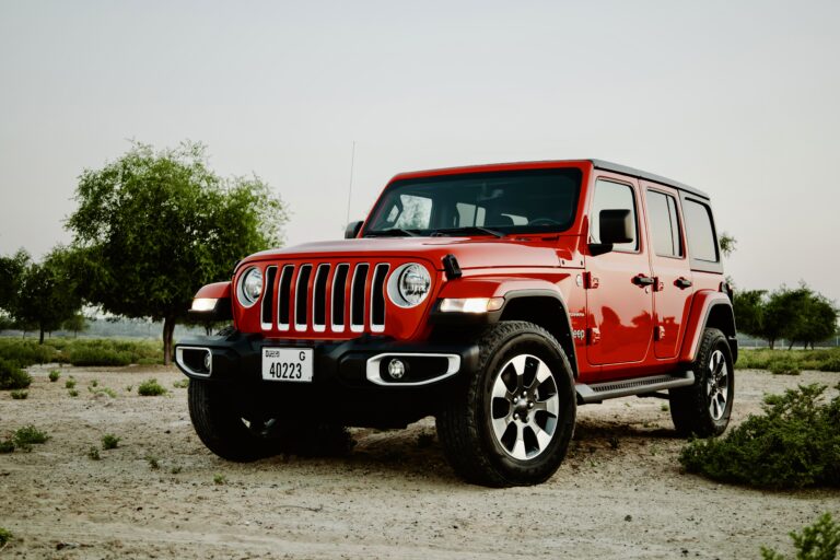 Bold red Jeep Wrangler V6 2022 for rent in Dubai offering powerful performance rugged design and exceptional off-road capability