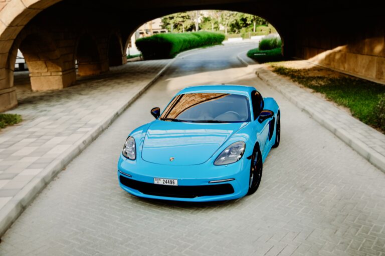 Sporty Miami Blue Porsche Cayman S for rent in Dubai offering thrilling performance sleek design and a luxurious driving experience