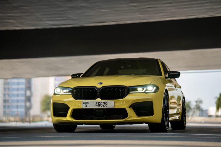 Striking yellow BMW M5 Competition 2023 for rent in Dubai offering high-performance engineering luxurious comfort and a dynamic driving experience