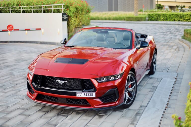 Powerful red Ford Mustang GT Cabrio 2024 for rent in Dubai offering a thrilling open-top driving experience with high-performance engineering sleek design and modern features