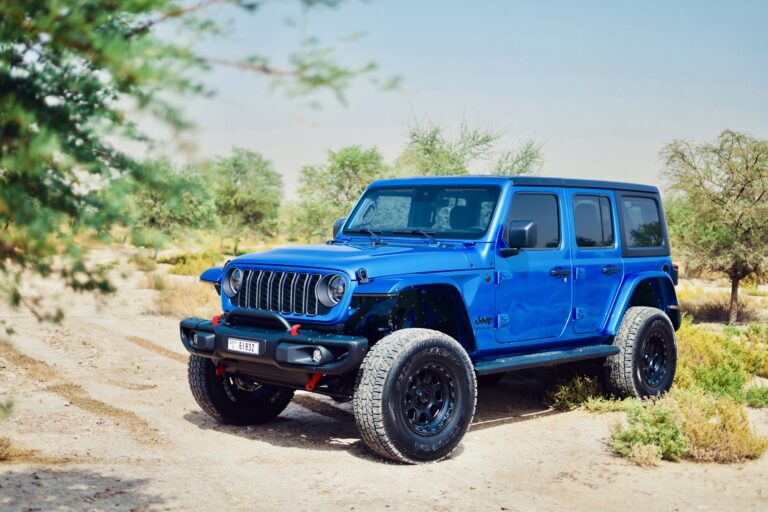 Rugged blue Jeep Wrangler 2024 for rent in Dubai offering off-road capability modern features and an adventurous open-top driving experience