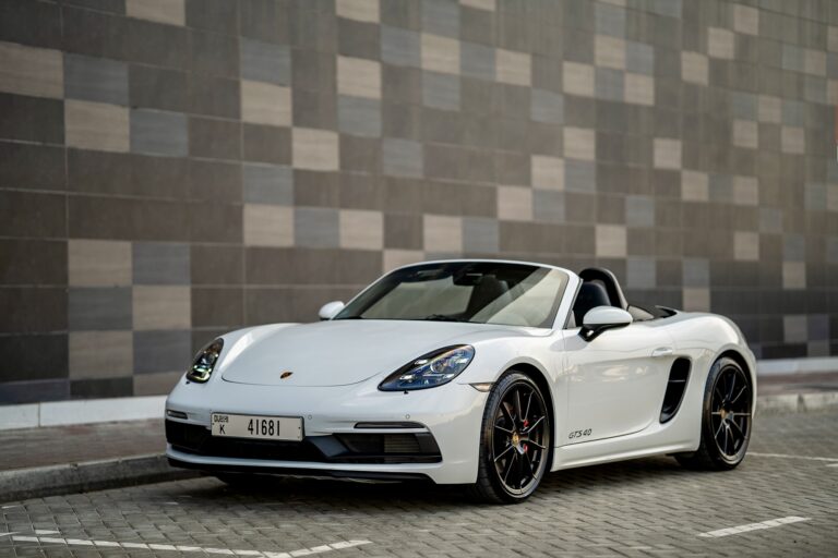 Elegant white Porsche Boxster GTS for rent in Dubai offering a thrilling open-top driving experience with high-performance engineering sleek design and advanced technology