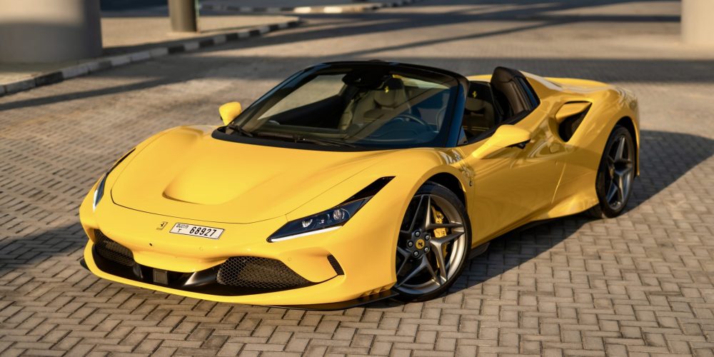 Exotic yellow Ferrari F8 Tributo Spider 2022 for rent in Dubai offering a thrilling open-top driving experience with unmatched luxury and performance