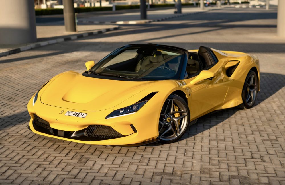 Exotic yellow Ferrari F8 Tributo Spider 2022 for rent in Dubai offering a thrilling open-top driving experience with unmatched luxury and performance