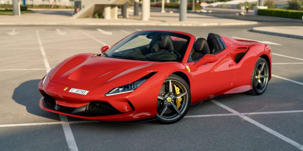 Iconic red Ferrari F8 Tributo Spider 2023 for rent in Dubai delivering a thrilling open-top driving experience with unparalleled luxury and performance