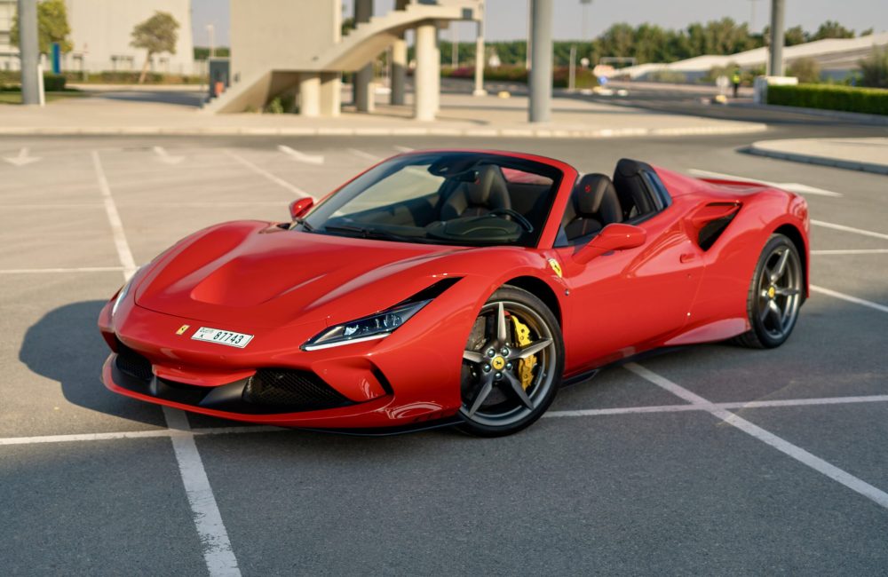 Iconic red Ferrari F8 Tributo Spider 2023 for rent in Dubai delivering a thrilling open-top driving experience with unparalleled luxury and performance