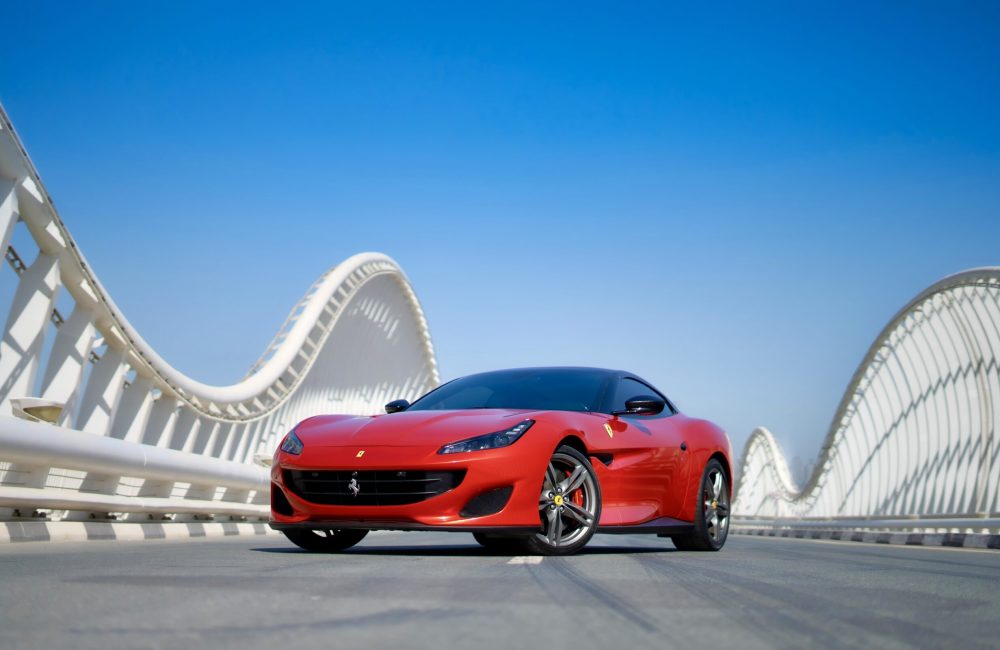 Stunning red Ferrari Portofino 2019 with a black roof for rent in Dubai delivering luxurious design and exhilarating performance