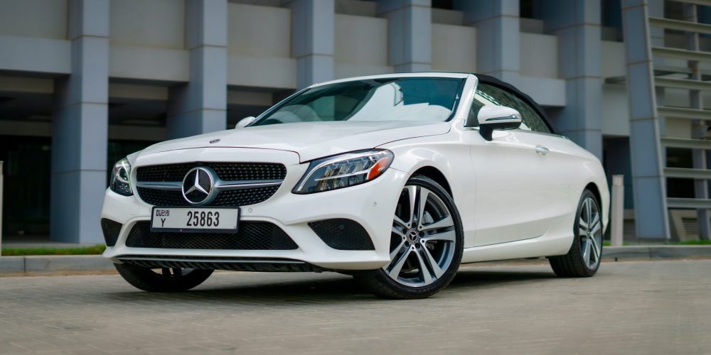 Elegant white Mercedes C300 Cabrio 2021 for rent in Dubai offering a luxurious open-top driving experience with exceptional comfort and performance