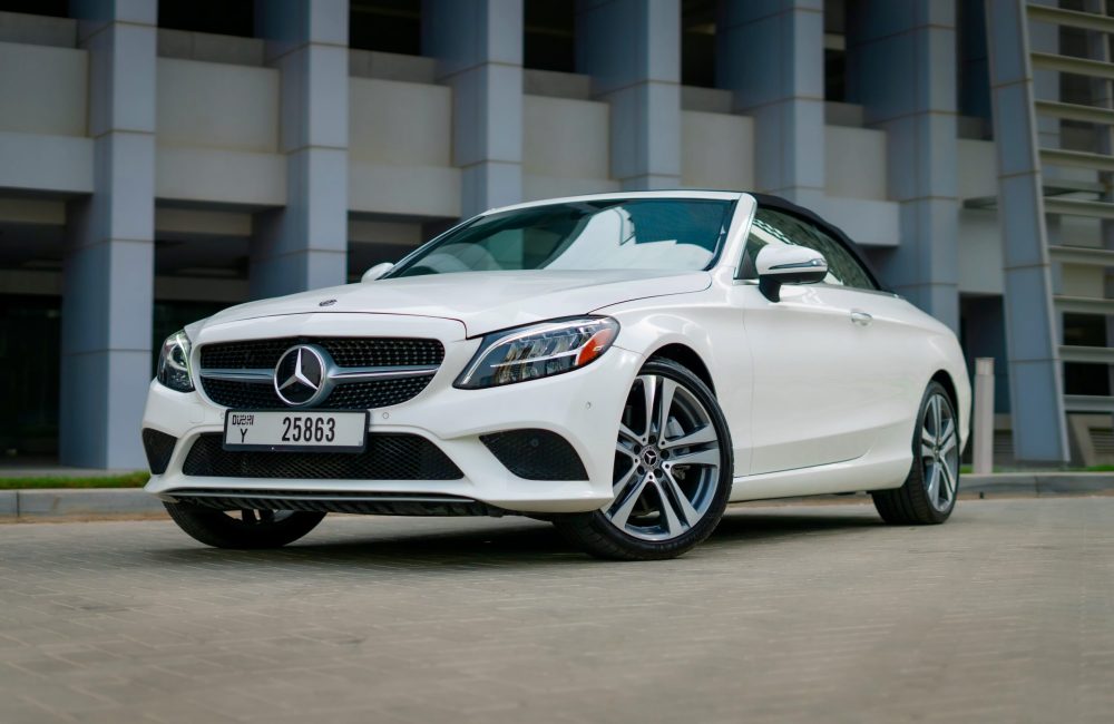 Elegant white Mercedes C300 Cabrio 2021 for rent in Dubai offering a luxurious open-top driving experience with exceptional comfort and performance