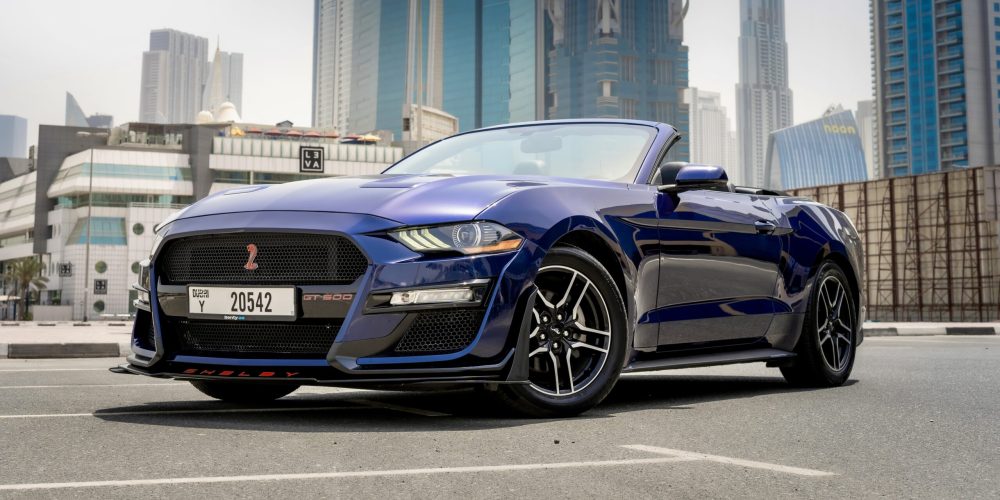 Stylish dark blue Ford Mustang Cabrio 2020 for rent in Dubai offering a sporty open-top driving experience with classic design and performance