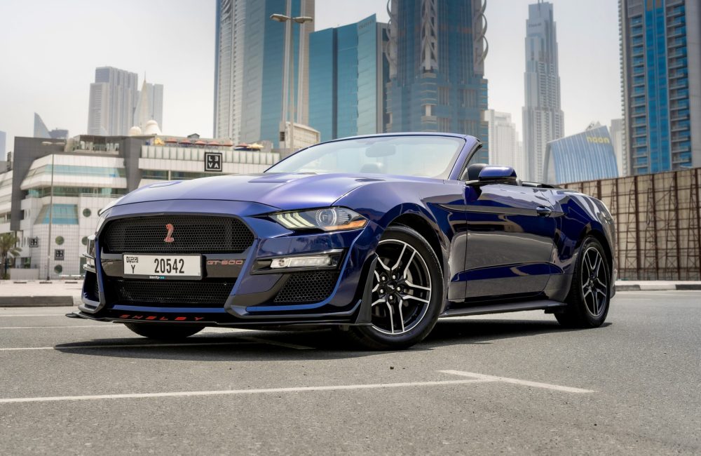 Stylish dark blue Ford Mustang Cabrio 2020 for rent in Dubai offering a sporty open-top driving experience with classic design and performance