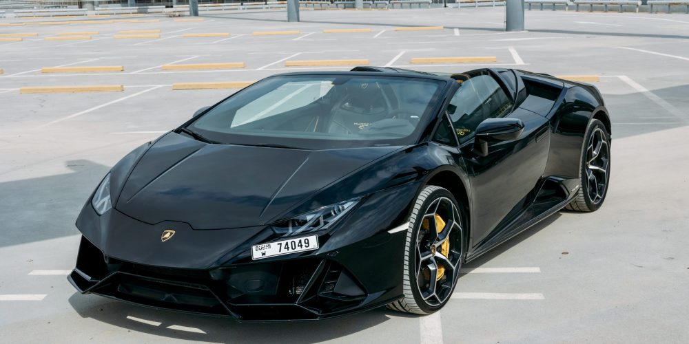 Luxurious black Lamborghini Evo Spyder 2023 for rent in Dubai delivering a thrilling open-top driving experience with exceptional performance and style