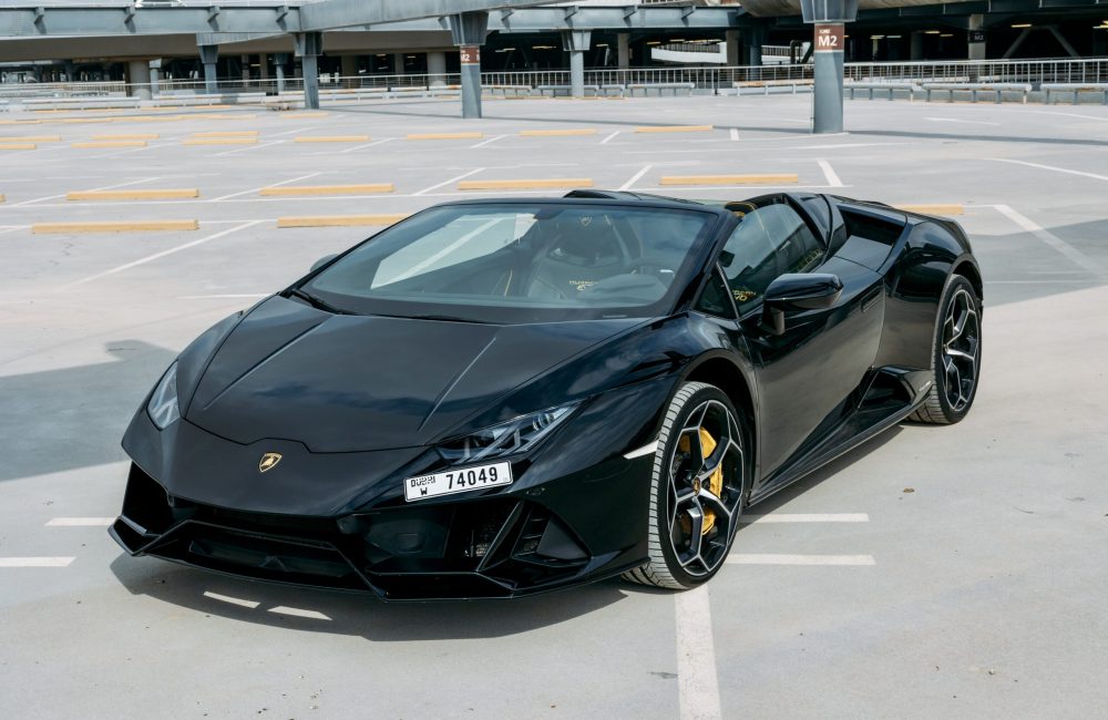 Luxurious black Lamborghini Evo Spyder 2023 for rent in Dubai delivering a thrilling open-top driving experience with exceptional performance and style