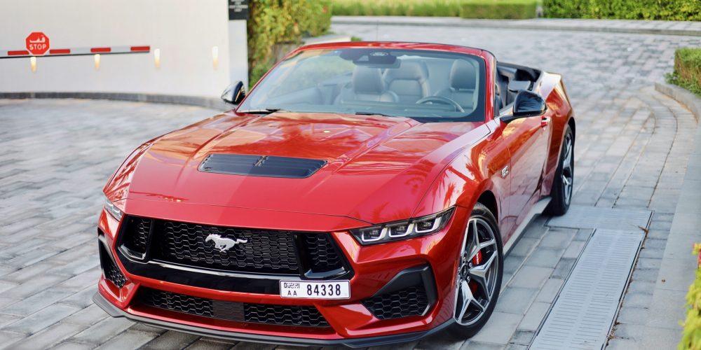 Powerful red Ford Mustang GT Cabrio 2024 for rent in Dubai offering a thrilling open-top driving experience with high-performance engineering sleek design and modern features