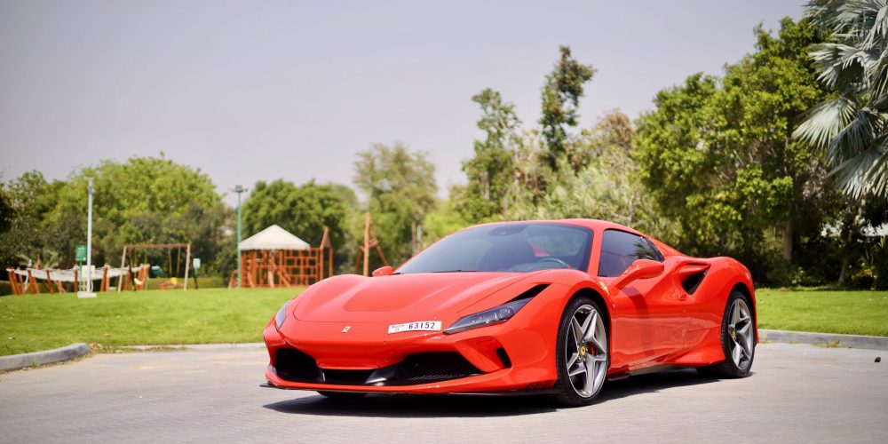 Iconic red Ferrari F8 Tributo Spider for rent in Dubai offering a thrilling open-top driving experience with exceptional performance luxurious design and advanced technology