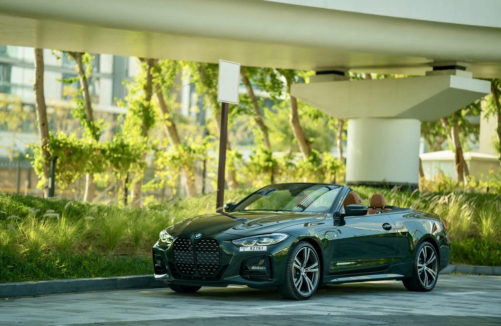 Elegant green BMW 420 Convertible 2023 for rent in Dubai offering a luxurious open-top driving experience with advanced technology and sporty performance