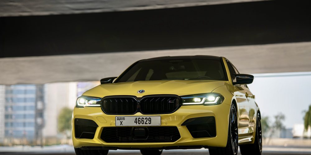 Striking yellow BMW M5 Competition 2023 for rent in Dubai offering high-performance engineering luxurious comfort and a dynamic driving experience