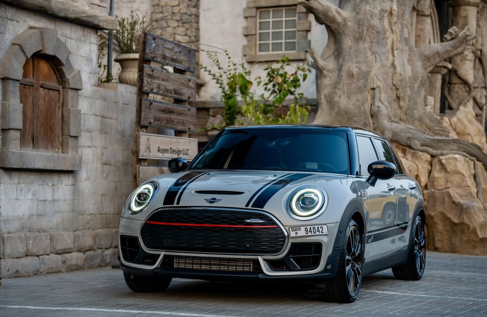 Sporty white Mini Cooper Clubman JCW for rent in Dubai offering a unique blend of compact design high-performance engineering and modern luxury for an exciting driving experience