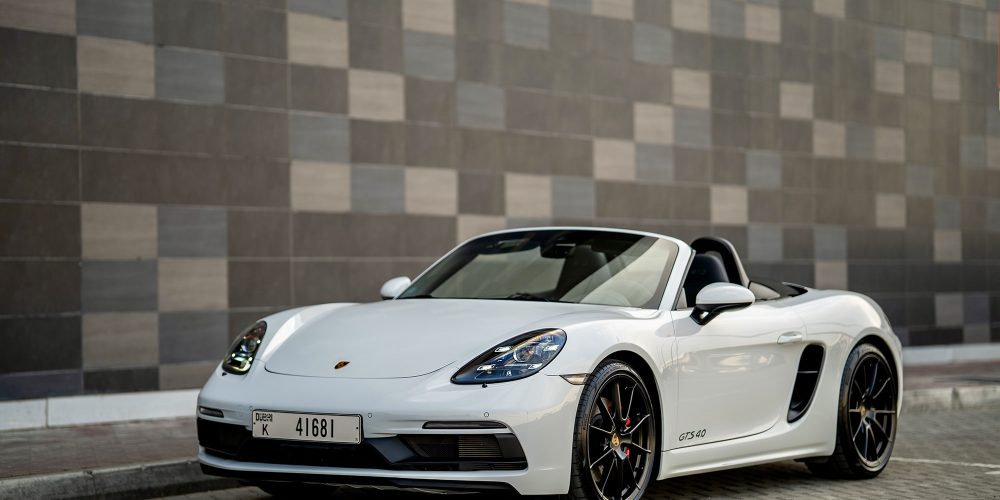 Elegant white Porsche Boxster GTS for rent in Dubai offering a thrilling open-top driving experience with high-performance engineering sleek design and advanced technology