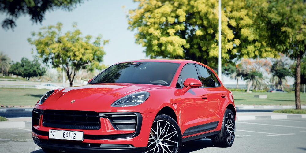 Sporty red Porsche Macan 2023 for rent in Dubai offering a perfect combination of luxury dynamic performance and advanced technology for an exceptional driving experience