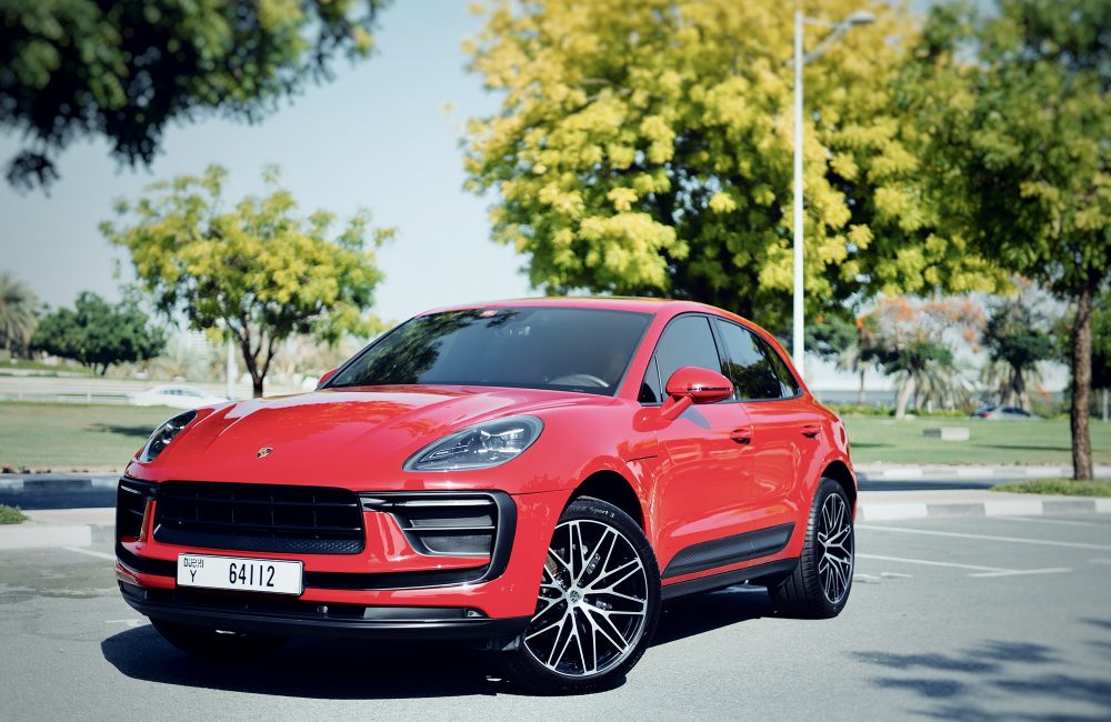 Sporty red Porsche Macan 2023 for rent in Dubai offering a perfect combination of luxury dynamic performance and advanced technology for an exceptional driving experience